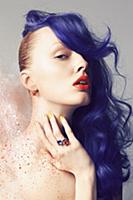 A young woman with a purple hair piece and a dusti