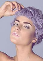 A young woman with pastel coloured make up wearing