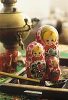 Matryoshka dolls, samovar and glasses in backgroun