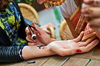 Process of drawing mendi applying on the arm