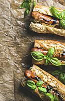 Homemade grilled sausage dogs in baguette with car