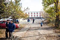 Bulgaria / 2013 / Refugees walk out of a decrepit 