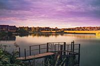 Silent pond surface in sunset time. Tranquil lands